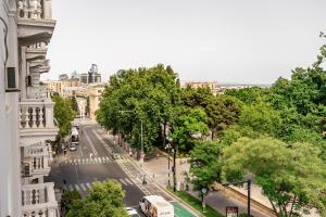 a view of a city street with trees and buses at Parliament Hotel & Restaurant in Baku