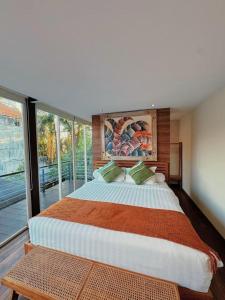 a bedroom with a large bed and a large window at 3BR Villa mit Pool, Villa Jovino, Jameja Kerobokan in Kerobokan