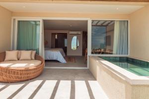 a villa with a swimming pool and a bedroom at Pousada Aysú in Japaratinga +14 photos