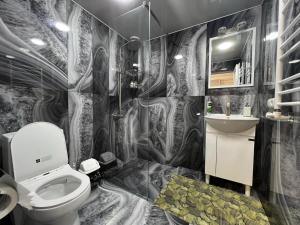 a bathroom with a toilet and a sink at Hotel in Yerevan in Yerevan