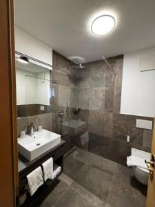a bathroom with a sink and a shower at Hotel Laerchenhain in San Valentino alla Muta +22 photos