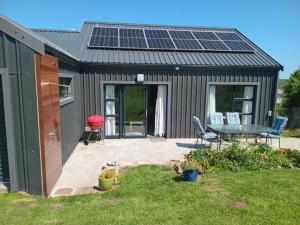 a small shed with solar panels on the roof at Zebra Crossing in Bushmans River Village