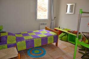 a bedroom with a bed and a table in it at Villa Pepy in Salviac