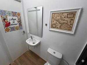 a bathroom with a toilet and a sink and a mirror at Estudio Las Rozas de Madrid in Las Rozas de Madrid