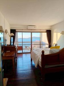 a bedroom with a bed and a view of the ocean at Jansom Beach Resort in Ranong +156 photos