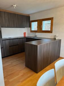 cocina con encimera de madera y suelo de madera en Renovated-Spacious apartment up to 6 people in Flims, en Flims