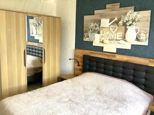 a bedroom with a bed with a mirror and a bed sidx sidx sidx at La petite cauchoise in Bacqueville-en-Caux