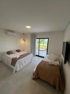 En eller flere senge i et værelse på Casa Mar dos Coqueirais + 34 billeder