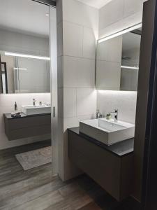 a bathroom with two sinks and a large mirror at Sun Tower in Zurich