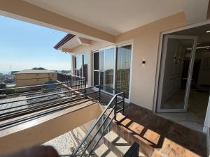 a balcony with a view of a building at The White Lotus Homestay in Dharmsala