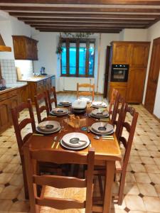 a wooden table in a kitchen with a dining room at Gîte "EN VALROMEY" au pied du Grand Colombier in Munet