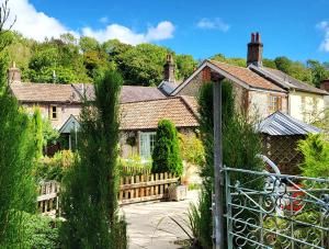 an external view of a house with a fence at Escape the Ordinary in Piddletrenthide