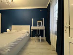 a blue bedroom with a bed and a mirror at Hotel in Yerevan in Yerevan