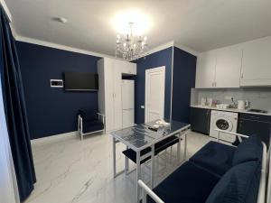 a blue living room with a table and a couch at Hotel in Yerevan in Yerevan