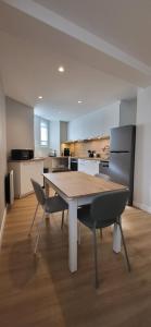 a kitchen with a wooden table and two chairs at T2 Hyper-centre Brest CHU Morvan & Transports in Brest