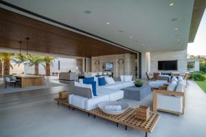 a living room with a white couch and blue pillows at Casa Elije in San José del Cabo