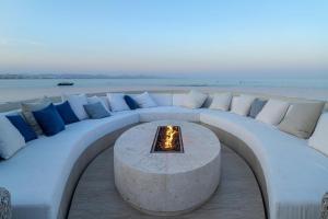 a white couch with a fire pit on the beach at Casa Elije in San José del Cabo +69 photos