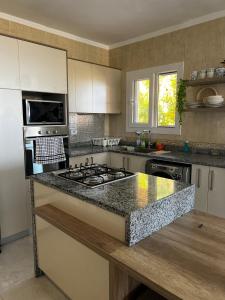 a kitchen with a stove and a counter top at Private Villa Sea View 5BR in Ain Sokhna
