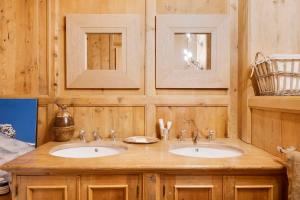 a bathroom with two sinks and two mirrors at casa storica nel centro di Bever 4 camere in Bever +51 photos