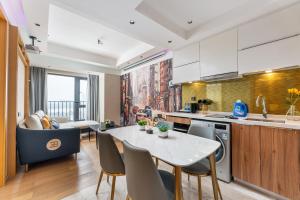 a kitchen and living room with a table and chairs at Yizhimei Apartment Hotel-Guangzhou Huijin International Financial Center Keyun Road Subway STN Branch in Guangzhou