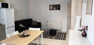 a living room with a table and a couch at Studio relaxe in Mitry-Mory