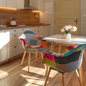 a kitchen with a table and two chairs at Apartmány Bašta & Wellness in Sušice +77 photos