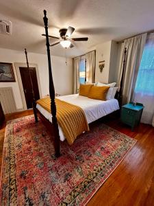 a bedroom with a bed with a ceiling fan and a rug at Derby and Downtown in Louisville