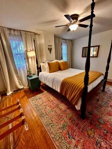 a bedroom with a bed and a ceiling fan at Derby and Downtown in Louisville