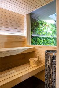 a sauna with a window and a bucket at TheHouse - Apartment Kamenitza in Velingrad