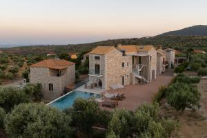 an aerial view of a villa with a swimming pool at Liokrina suites in Koroni