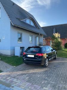 a black car parked in front of a house at Haus TimpeTe am Breetzer Bodden in Vieregge