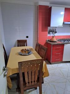 a kitchen with a table and chairs in a room at Haytam in Sale