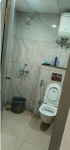 a bathroom with a toilet and a sink at Stodio apartment Noida greater Noida in Ghaziabad