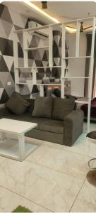 a living room with a couch and a table at Stodio apartment Noida greater Noida in Ghaziabad