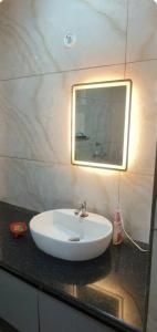 a white sink in a bathroom with a mirror at Stodio apartment Noida greater Noida in Ghaziabad