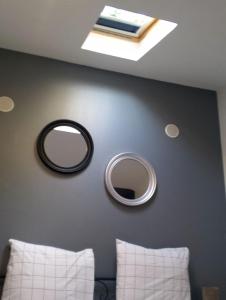 a bedroom with two mirrors on the wall at Magnifique Studios proche de Paris dans le Yvelines in Ecquevilly