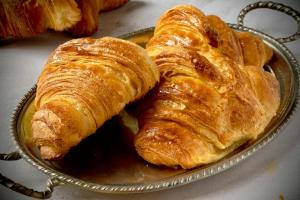 two croissants on a plate on a table at Al Civico 73 in Carpi
