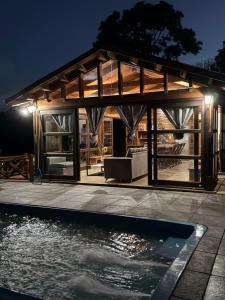 a house with a pool in front of it at Luz de campo in Dos de Mayo