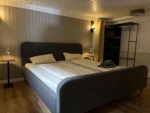 a large bed in a room with two tables at Ferienwohnung Korbach in Korbach