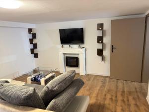 a living room with a couch and a fireplace at Ferienwohnung Korbach in Korbach