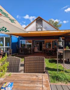 a patio with chairs and tables and a building at Seeschwalbe 78 in Rechlin