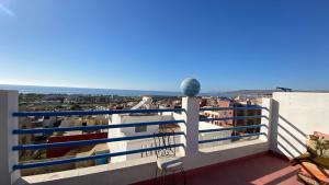 a balcony with a view of the ocean at Gypsy Surf Maroc Hostel in Tamraght Ouzdar