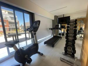 a gym with two tread machines and a large window at Apartamento para 2 personas in Buenos Aires