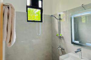 a bathroom with a shower and a sink and a window at Gamagedara Resort in Dambulla +67 photos