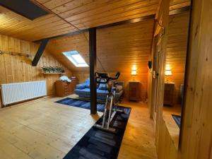 a gym with a treadmill in the middle of a room at Bunnyhill in Elchingen