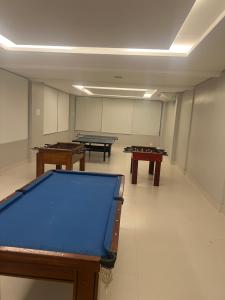 a room with three pool tables in it at Flat Palladium in São Vicente