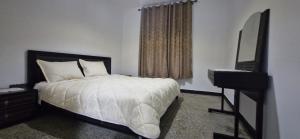 a bedroom with a bed and a mirror and a window at Appartement Océan in Rabat +2 photos