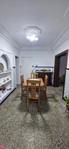 a dining room with a wooden table and chairs at Appartement Océan in Rabat