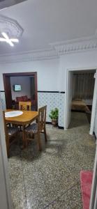 a dining room with a table and chairs and a bedroom at Appartement Océan in Rabat