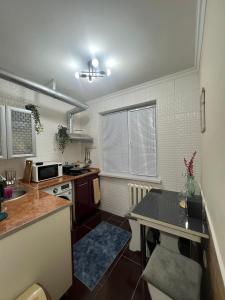 a kitchen with a sink and a counter top at 3х комнатная квартира in Shymkent